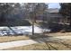 An exterior view showing the front of the residential building and a pond covered in ice at 8600 E Alameda Ave # 105, Denver, CO 80247