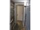 View down a hallway between a shiplap wall and a doorway at 8600 E Alameda Ave # 105, Denver, CO 80247