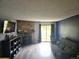 Relaxing living room with stone fireplace and sliding glass door access at 8600 E Alameda Ave # 105, Denver, CO 80247