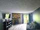 Cozy living room features a stone fireplace and natural light at 8600 E Alameda Ave # 105, Denver, CO 80247