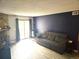 Living room featuring a stone fireplace and outdoor access at 8600 E Alameda Ave # 105, Denver, CO 80247