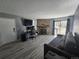 Living room featuring stone fireplace, sliding doors, and a comfortable couch at 8600 E Alameda Ave # 105, Denver, CO 80247