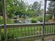 Scenic pond view from the porch, featuring a fountain and lush greenery at 8600 E Alameda Ave # 105, Denver, CO 80247