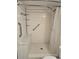 The accessible shower is tiled and has a handheld shower head at 8600 E Alameda Ave # 105, Denver, CO 80247