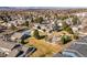 An aerial view of a residential area showing houses, a pool, putting green, and lots of green space and mature trees at 7176 S Vine E Cir, Centennial, CO 80122