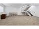 Finished basement features neutral carpet, white walls, and staircase to the main floor at 7176 S Vine E Cir, Centennial, CO 80122
