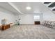 Finished basement offers neutral carpet, white walls, and access to the upper levels at 7176 S Vine E Cir, Centennial, CO 80122
