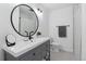 Bright bathroom featuring a round mirror, vanity with drawers, and a separated shower and toilet room at 7176 S Vine E Cir, Centennial, CO 80122