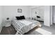 Modern bedroom with a mirrored closet, black and white bedding, and gray carpet flooring at 7176 S Vine E Cir, Centennial, CO 80122