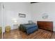 Bright bedroom features wood floors, an accent chair, dresser, and large window at 7176 S Vine E Cir, Centennial, CO 80122