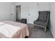 Neutral bedroom features cozy chair, light pink bedding, and a closet with white doors at 7176 S Vine E Cir, Centennial, CO 80122