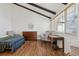 Vaulted bedroom with wood flooring, exposed beams, and a window with wood blinds at 7176 S Vine E Cir, Centennial, CO 80122