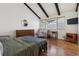 Bright bedroom with vaulted ceiling features wood floors, an accent chair, and a dresser at 7176 S Vine E Cir, Centennial, CO 80122
