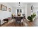 Open dining room with hardwood flooring, a modern light fixture, and ample seating space at 7176 S Vine E Cir, Centennial, CO 80122