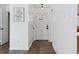 Bright foyer with hardwood floors, a white front door, and a light-colored wall with artwork at 7176 S Vine E Cir, Centennial, CO 80122