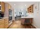 Spacious kitchen flows into the dining area, showcasing modern appliances and ample cabinetry at 7176 S Vine E Cir, Centennial, CO 80122