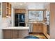 Well-lit kitchen featuring wood cabinets, stainless steel appliances, and a bright window at 7176 S Vine E Cir, Centennial, CO 80122
