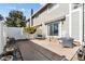 Enclosed back patio includes concrete floors, gray wicker furniture, and a privacy fence at 7176 S Vine E Cir, Centennial, CO 80122