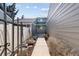 The image showcases a cement walkway leading to the front of the house, framed by fencing and landscaping at 7176 S Vine E Cir, Centennial, CO 80122
