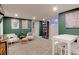 Finished basement with seating area, built-in shelving, and green accent wall at 2337 S Franklin St, Denver, CO 80210