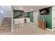 Basement bar with white cabinetry, built-in beverage cooler, and green accent wall at 2337 S Franklin St, Denver, CO 80210