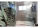 Bathroom featuring dark floral wallpaper, shower with gray subway tile, and glass door at 2337 S Franklin St, Denver, CO 80210