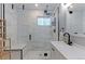 Modern bathroom with a glass-enclosed shower, white marble-style tiles, and sleek fixtures at 2337 S Franklin St, Denver, CO 80210