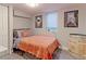 Bedroom with a cozy bed, framed art prints, natural light from the window, and decorative barrel at 2337 S Franklin St, Denver, CO 80210