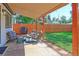 Charming covered patio features stylish seating, a grill, and a view of the lush, fenced backyard at 2337 S Franklin St, Denver, CO 80210
