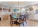 Elegant dining area with a chandelier, rustic wood table, and large windows for natural light at 2337 S Franklin St, Denver, CO 80210