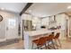 Bright, updated kitchen with stainless steel appliances, white cabinetry, quartz countertops, and island seating at 2337 S Franklin St, Denver, CO 80210
