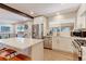 Stylish kitchen with a central island, stainless steel appliances, and seamless transition to the adjacent dining and living areas at 2337 S Franklin St, Denver, CO 80210
