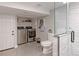 Bright laundry room and bathroom featuring stainless steel appliances, toilet, and glass shower at 2337 S Franklin St, Denver, CO 80210