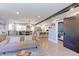 Open-concept living space showcases a modern design with exposed beam, hardwood floors, and seamless flow to the kitchen at 2337 S Franklin St, Denver, CO 80210