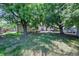 Fenced backyard with grass, mature trees and a patio perfect for summer gatherings and relaxing at 892 S Union Blvd, Lakewood, CO 80228