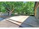 Expansive backyard with patio and mature shade trees offering ample space for outdoor relaxation and entertainment at 892 S Union Blvd, Lakewood, CO 80228