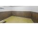 Unfinished basement with wood paneled walls, and tile floor, ready to be finished to the buyer's liking at 892 S Union Blvd, Lakewood, CO 80228
