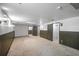 The large finished basement has multiple doorways and paneled walls at 892 S Union Blvd, Lakewood, CO 80228