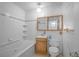 This bathroom showcases a white tiled jacuzzi tub, a sink, and a matching vanity at 892 S Union Blvd, Lakewood, CO 80228