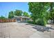 Expansive driveway providing ample parking space and leading to a detached garage at 892 S Union Blvd, Lakewood, CO 80228