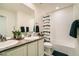 Bright bathroom with double sinks, modern fixtures, and a shower-tub combination with decorative shower curtain at 13341 Olive St, Thornton, CO 80602