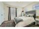 Comfortable bedroom featuring plush carpet, neutral walls, and soft gray upholstered headboard at 13341 Olive St, Thornton, CO 80602