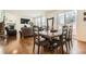 Bright dining room area showcases hardwood flooring, large window views, and living room at 13341 Olive St, Thornton, CO 80602