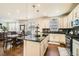 Open kitchen featuring granite countertops, stainless appliances, and an island, seamlessly connected to a dining area at 13341 Olive St, Thornton, CO 80602