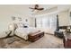 Spacious primary bedroom featuring a tray ceiling, sitting area, and plenty of natural light at 13341 Olive St, Thornton, CO 80602