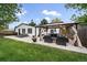 Spacious backyard featuring a gazebo with outdoor seating, dining area, lounge chairs, and lush lawn at 2865 S Cherry Way, Denver, CO 80222