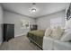 Serene bedroom with soft carpet, abundant natural light from windows, and stylish dark wood dresser at 2865 S Cherry Way, Denver, CO 80222