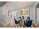 Dining room featuring hardwood floors, a modern chandelier, and view to the kitchen at 2865 S Cherry Way, Denver, CO 80222