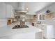 Bright kitchen with stainless appliances, island cooktop, and an open layout at 2865 S Cherry Way, Denver, CO 80222