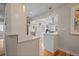 Bright kitchen featuring white cabinets, stainless steel appliances, and a kitchen island with bar seating at 2865 S Cherry Way, Denver, CO 80222